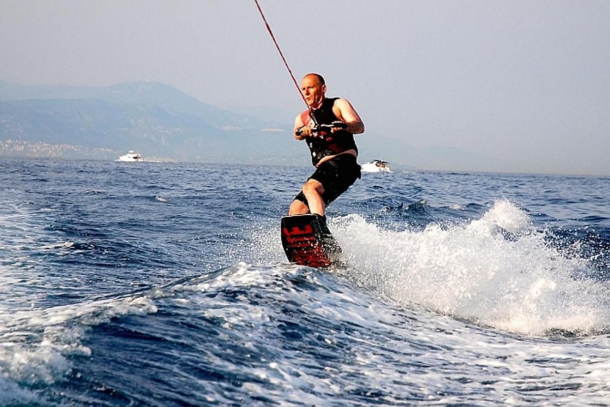 My life so far: The chief executive wakeboarding on Lake Geneva (above), also in 2016.