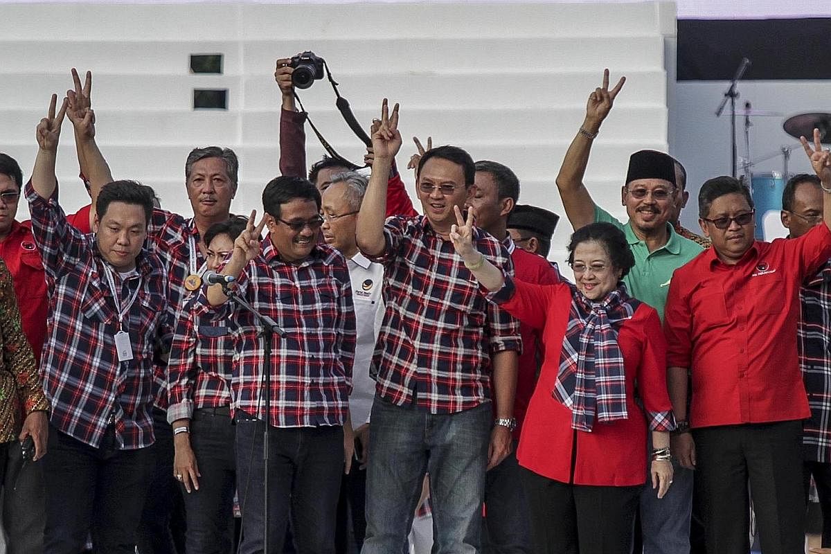 (Front row, from left) Running mates Djarot and Basuki with former Indonesian president Megawati at a campaign concert on Saturday. The pair are backed by Ms Megawati's PDI-P. The most recent polling released by Charta Politika last week shows them i