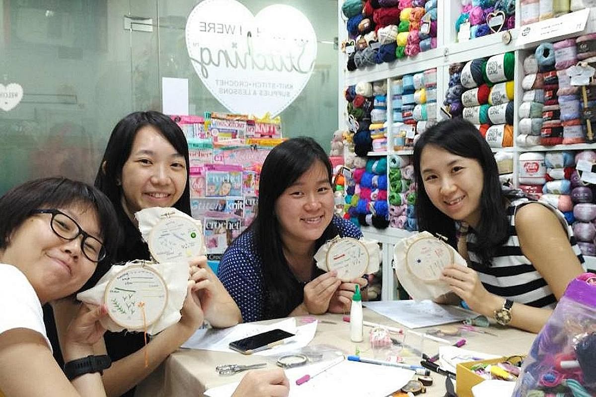 Co-founder of Sew Into It Amy Toh (standing) with her students Ng Hui Ling (sitting) and Ms Ng's daughter, Janelle, who learnt to make messenger bags. Members of Pasir Ris Sewing Ladies (from far left) Ms Romnah Omar, Ms Suhaila Jamat, Ms Hamidah Mik