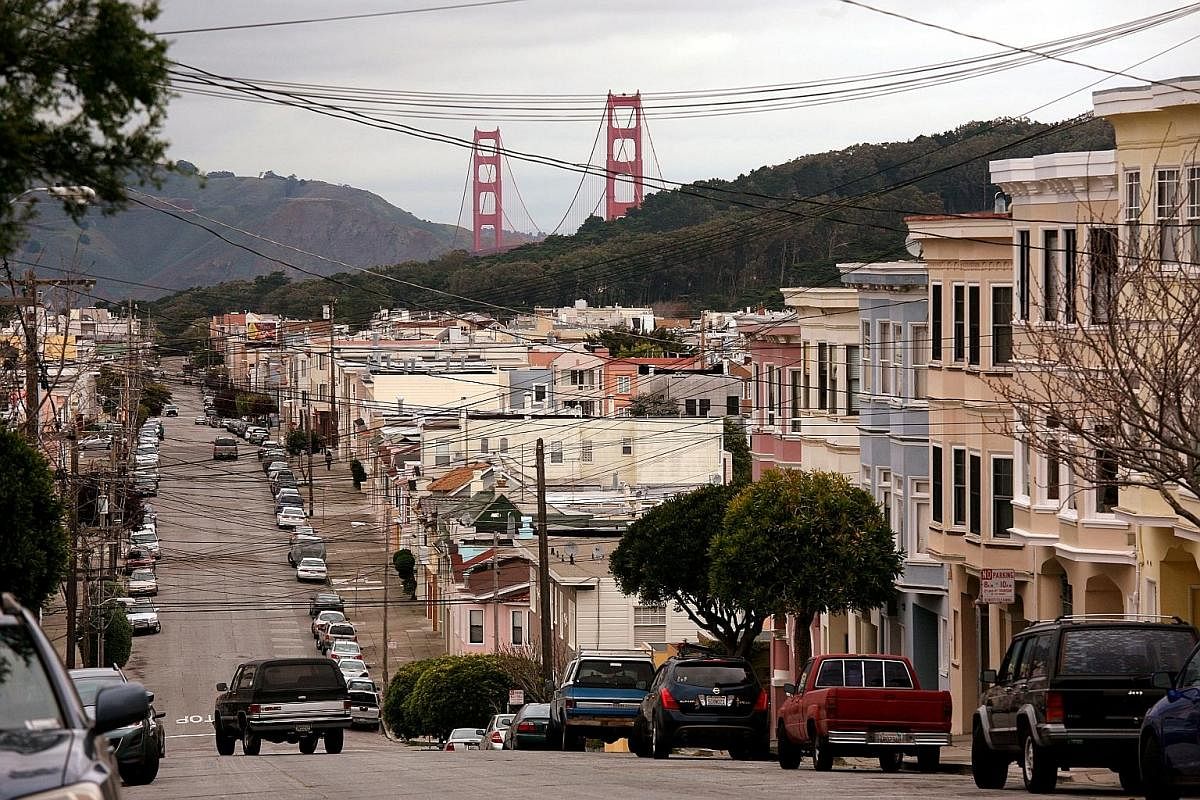 The Golden Gate Bridge (above) rises above a neighbourhood in the Richmond District in San Francisco; and the Ferry Building (left). This mural, depicting female icons around the world, is found on the facade of the Women's Building (above) in San Fr