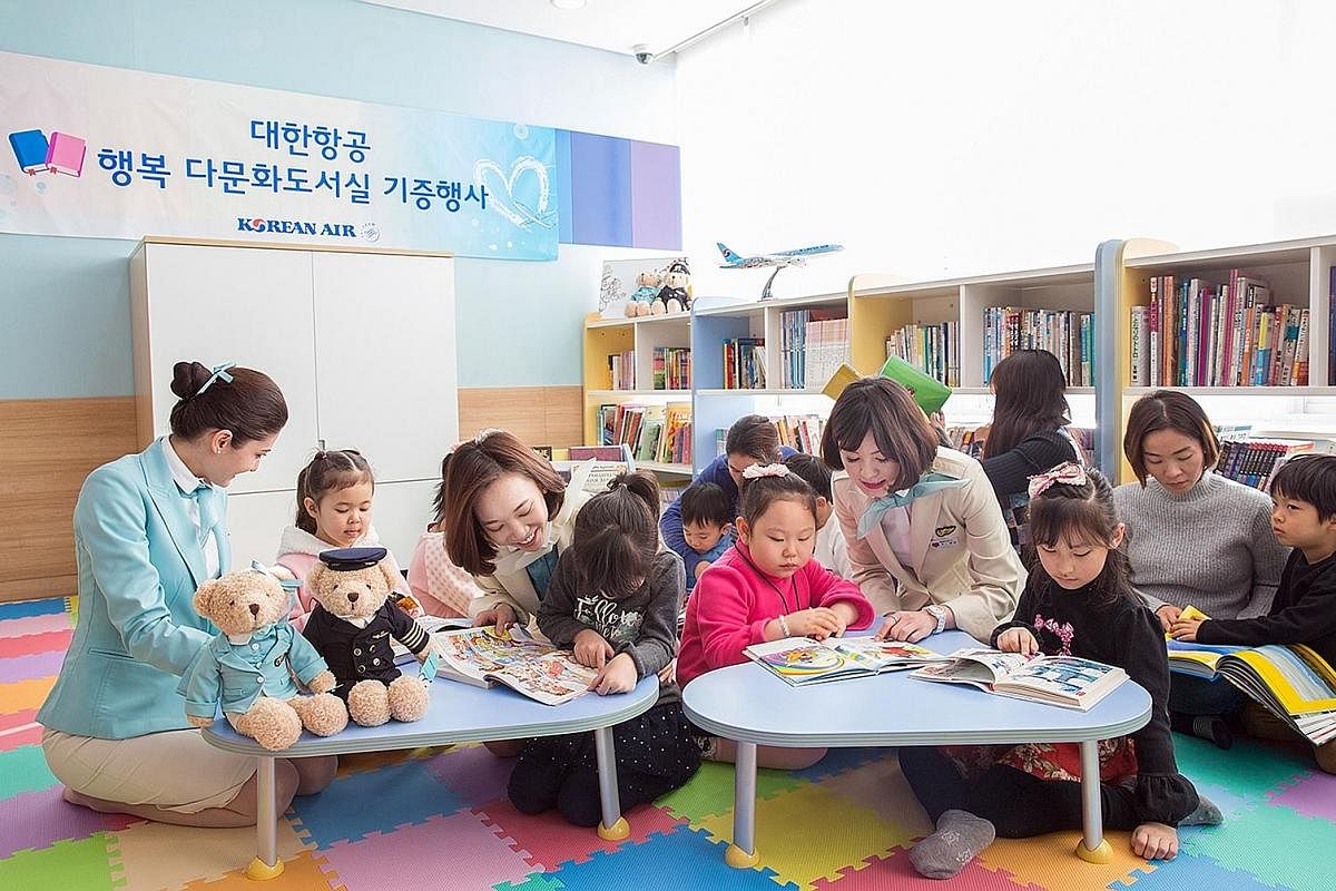 Korean Air stewardesses reading to children at a multicultural library in Gangseo district in western Seoul. The airline has donated 3,200 books in various languages to the library as part of its CSR efforts. Mr Seo Seong Youl, who runs a 1913 Songje