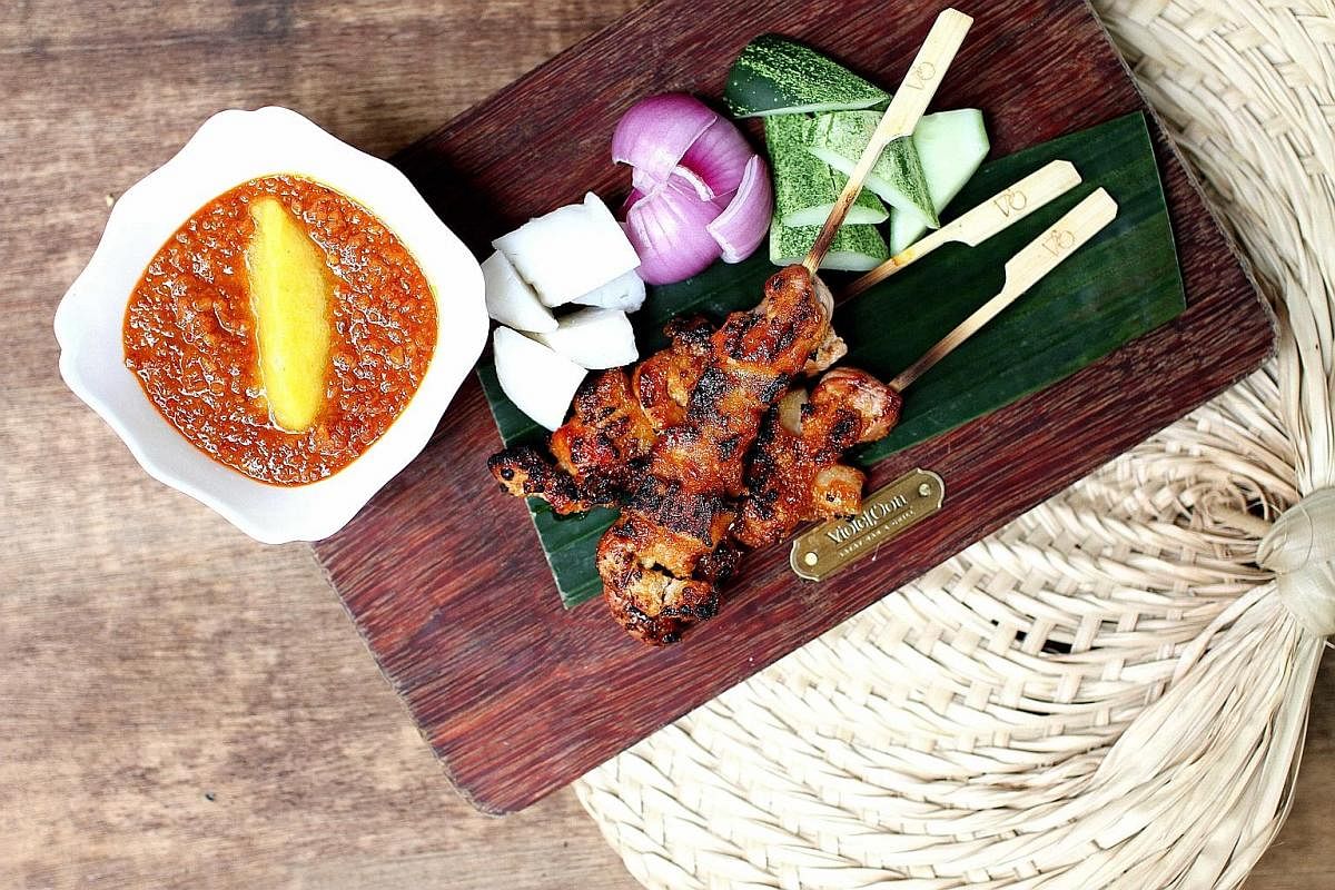 The purple sweet potato bun has skin that is green and black from green tea and bamboo charcoal. Chicken Satay (above) with chunky pieces of meat and gravy topped with grated pineapple. Tender and flavourful Daging Panggang Sambal Hijau (left).