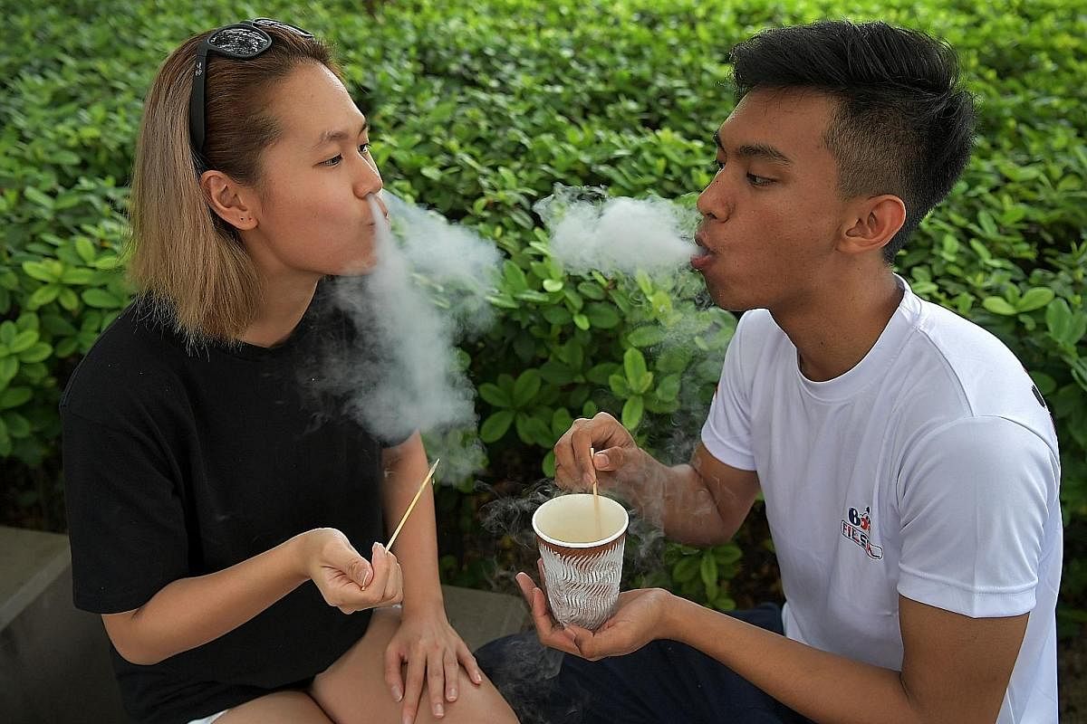 A staff member at Coyoro prepares the dessert using liquid nitrogen. Abracowdabra's co-owner Evelyn Wang and colleague Mohd Noor Shahlihin Mohd Salleh taking a breather with Dragon's Breath.