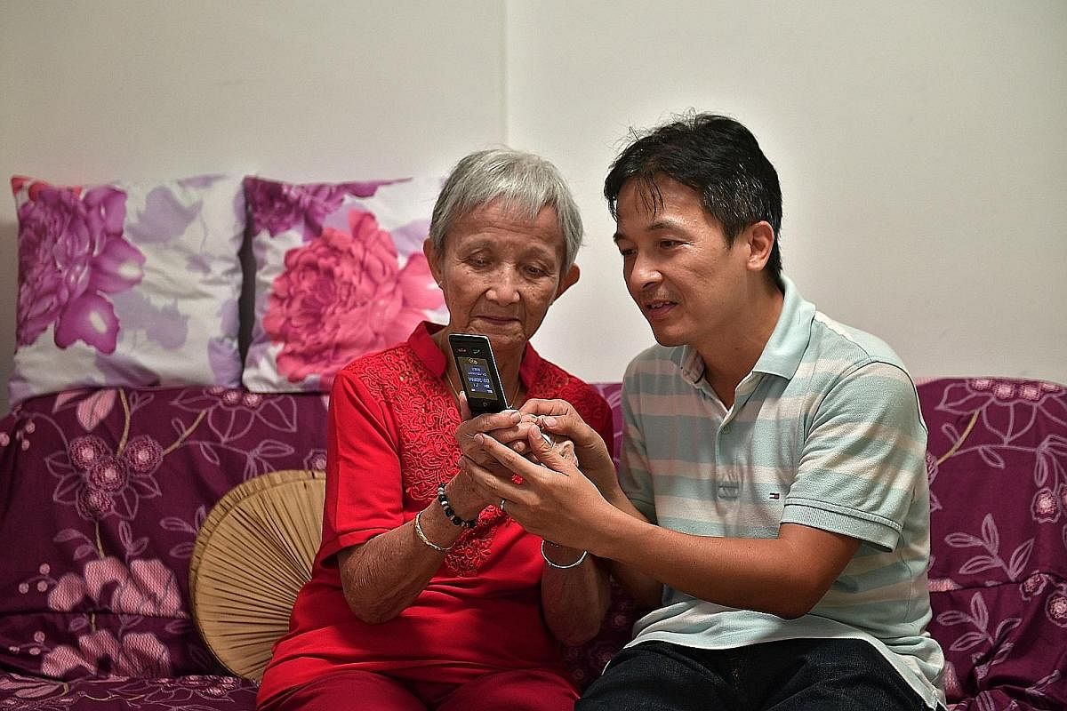 Retiree Ong Ah Tee relies on her son Danny Toh (both above) to teach her how to use a 3G phone.