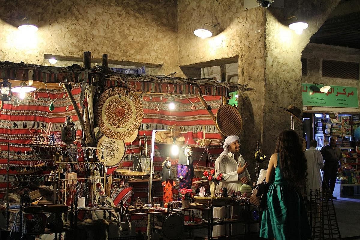 Bangle-maker Mohammed Aslam (above), who is from Jaipur in India, has been in Doha for close to a decade; and the Souk Waqif (top), which comes alive after sunset and sells everything from fabrics to gold. Falcons (right) are the pride of their Qatar