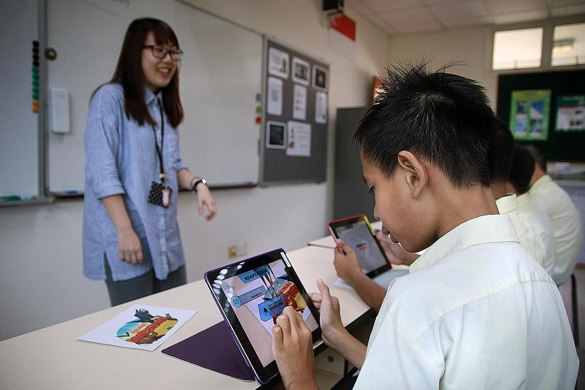 The Dinosaurs Among Us app lets users plant virtual life-sized dinosaurs in the real world on their phones. Metta School science teacher Laura Lim using augmented reality to teach students the process of animal adaptation.
