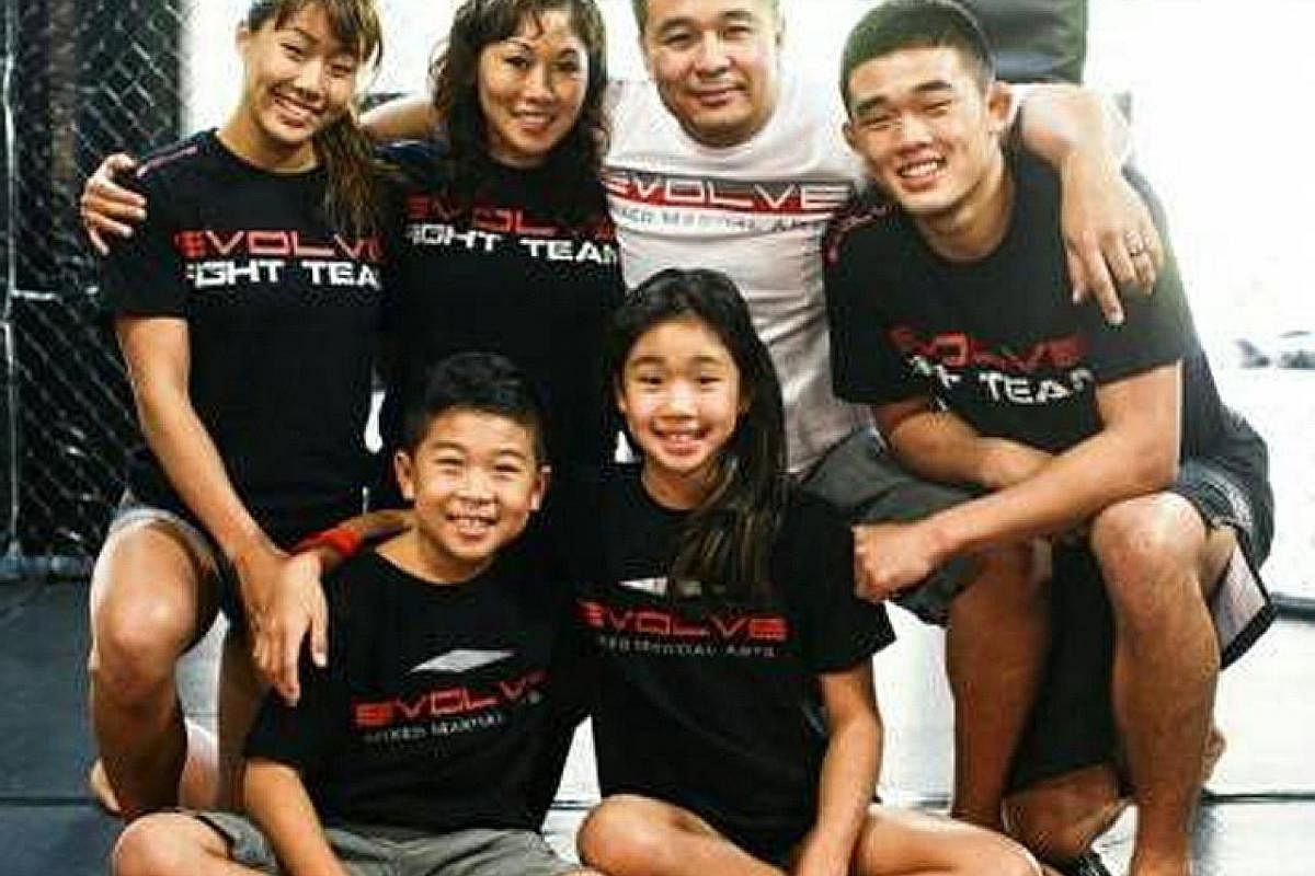 My life so far: Mixed martial arts fighter Angela Lee with her family - her mother Jewelz, father Ken, brother Christian, sister Victoria and youngest sibling Adrian.