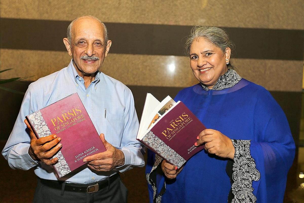 Mr Rustom Kanga with Mrs Subina Aurora Khaneja, who completed the book The Parsis Of Singapore, History, Culture, Cuisine. The book features photographs showing furniture and a picture of the sacred fire (far left) and a sace on a Chinese vase (left)