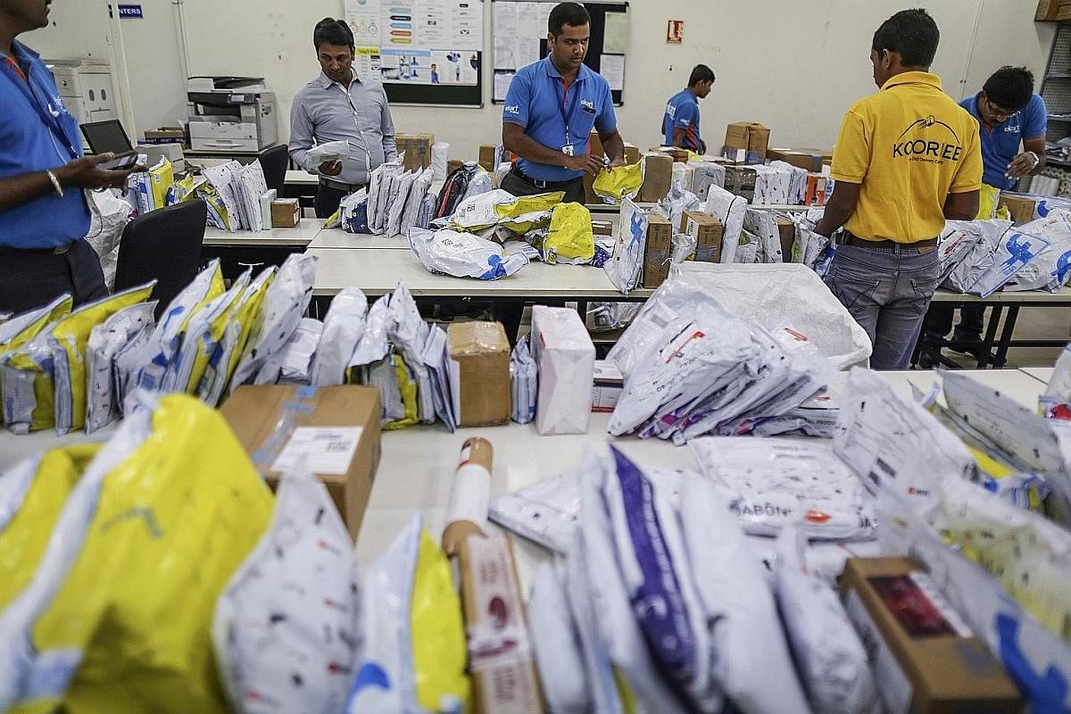 A happy Flipkart customer takes delivery of her package in Bengaluru, India. Deliverymen are the one human element in e-commerce transactions, as firms try to woo customers with the best buyer experience. E-commerce is booming in India, with more tha