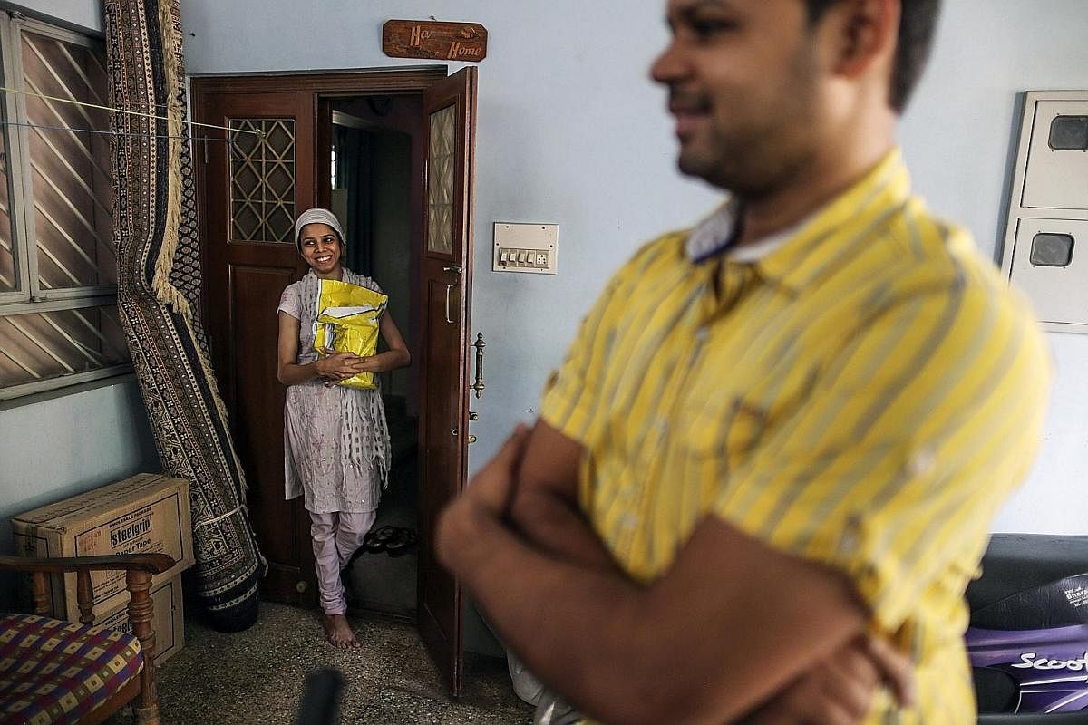 A happy Flipkart customer takes delivery of her package in Bengaluru, India. Deliverymen are the one human element in e-commerce transactions, as firms try to woo customers with the best buyer experience. E-commerce is booming in India, with more tha