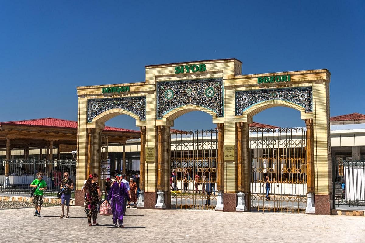 The trifold arch, decorated with dark blue mosaic tiles, forms the entrance of Siab Bazaar.