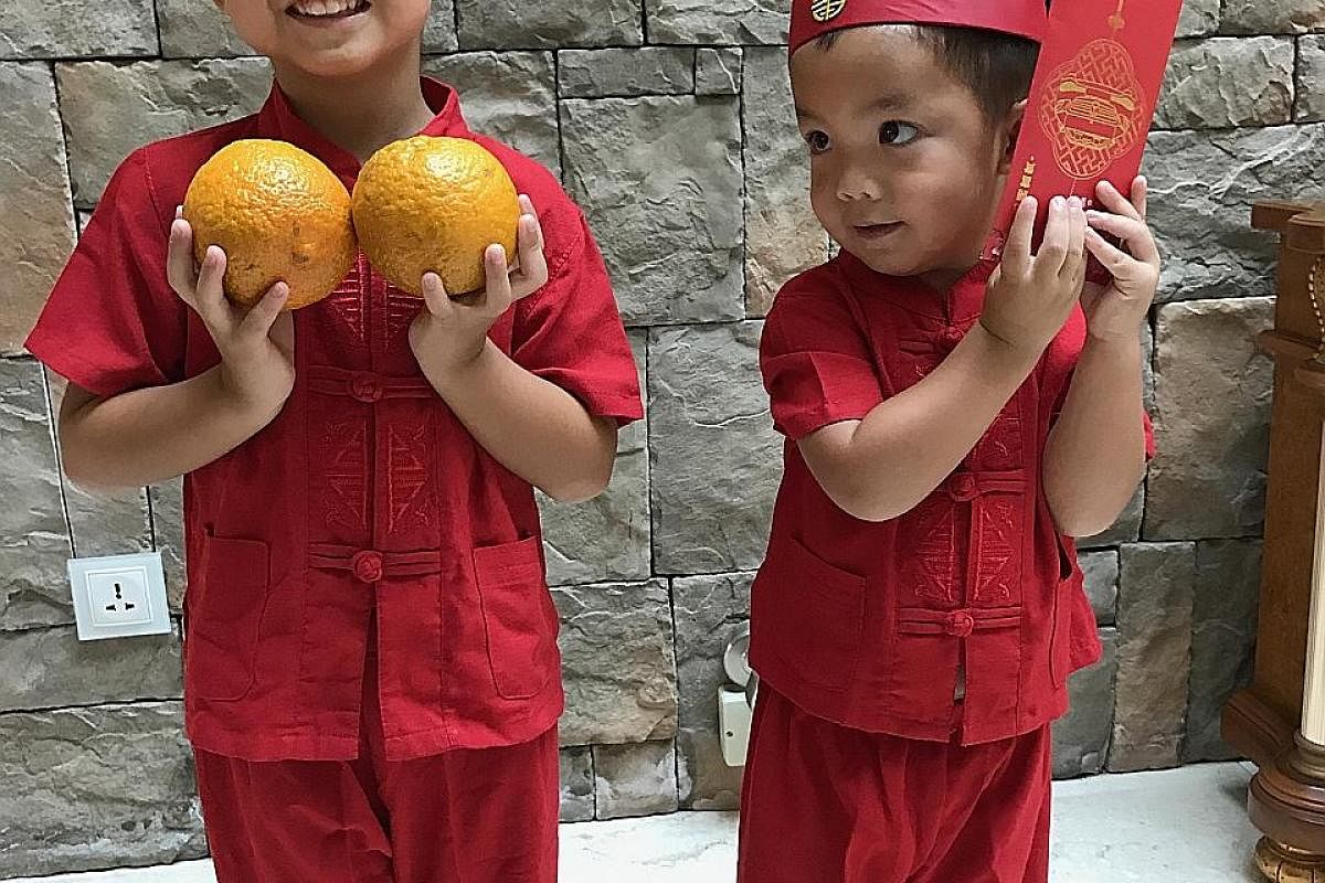 Shan Wee with his older son Ciran, when he was two years old, during a family photo shoot. Shan Wee's sons Ciaran, four, and Ruan, two, celebrating Chinese New Year this year.