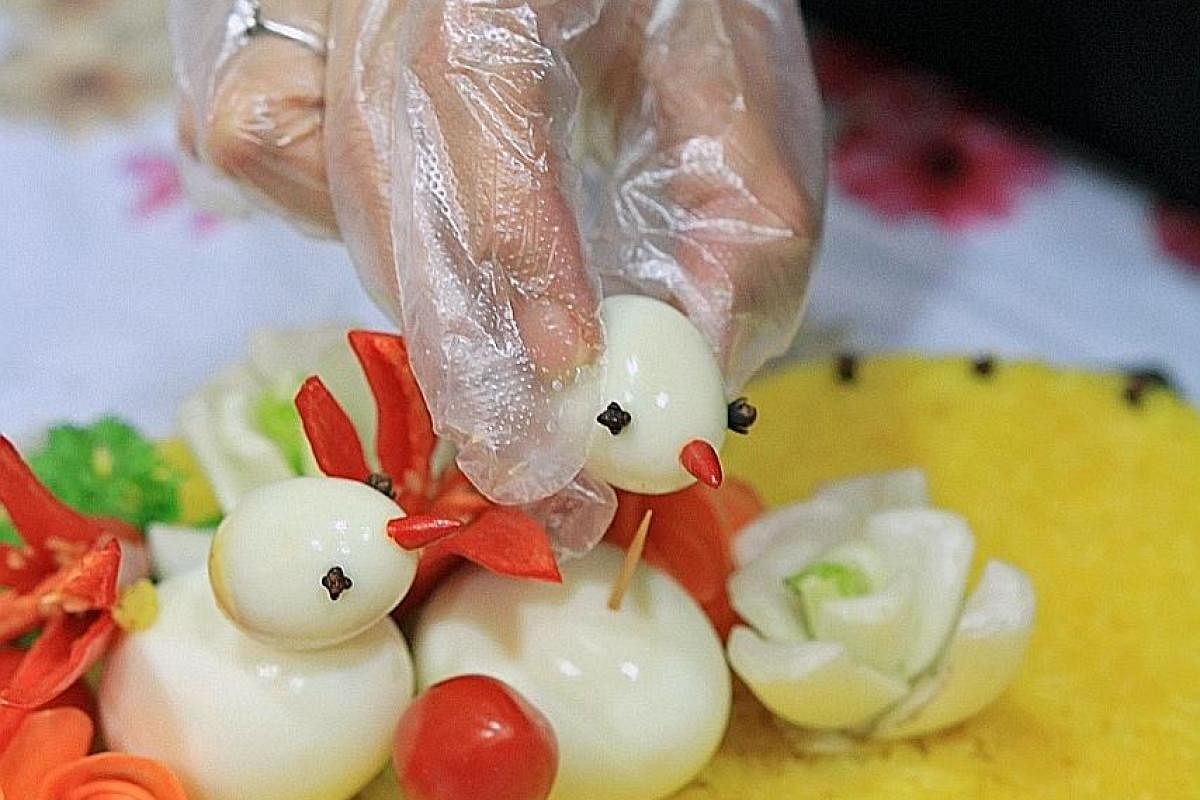 The pulut kuning cake by Madam Julia Sallim has "birds" made from eggs and vegetable "flowers".