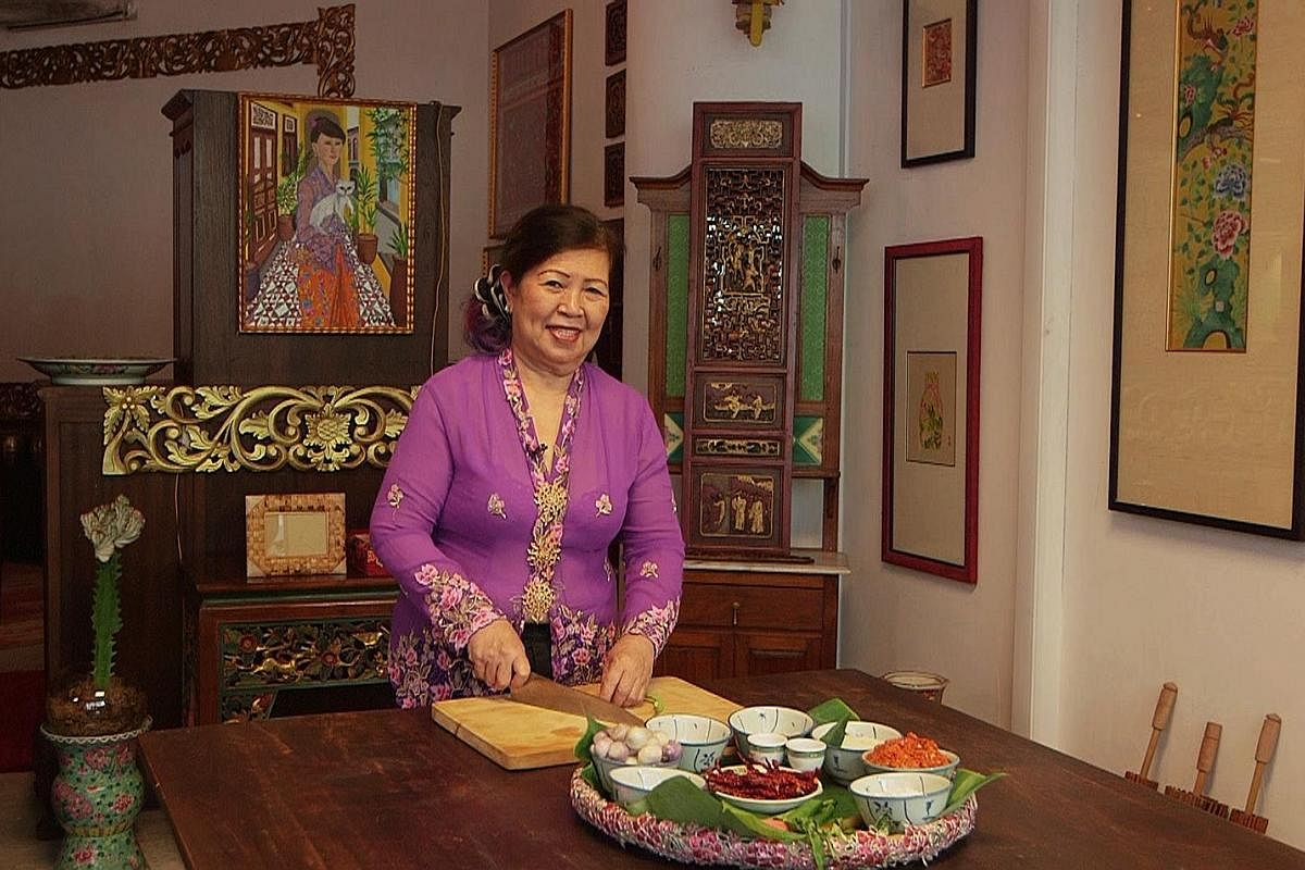 Executive sous chef Shirley Tay demonstrates the cooking of nasi ulam.