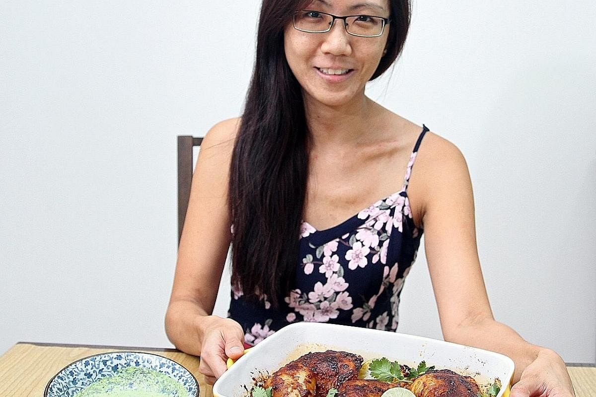 Ms Lin Tian Min with her Peruvian-style chicken, which is served with a tangy green sauce.