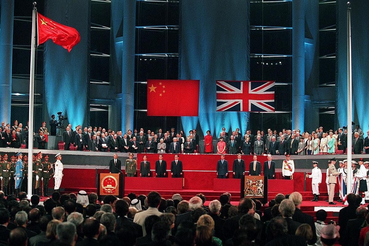 Then Chinese leader Deng Xiaoping hosting a meeting with then British Prime Minister Margaret Thatcher in Beijing on Sept 24, 1982. Mr Chris Patten, the 28th and last governor of colonial Hong Kong, receiving the Union Jack after it was lowered for t