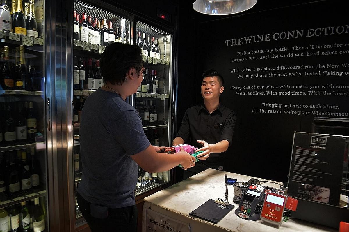 Wine Connection is among retailers which have come on board to serve as collection points. Park N Parcel user Merissa Lim collecting her parcel from the Toy Outpost outlet at Waterway Point.