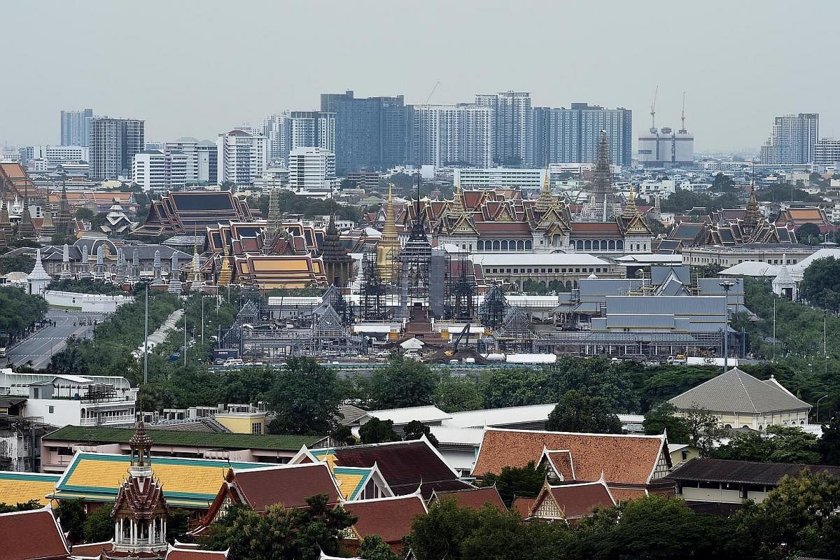 Left: The funeral pyre and surrounding pavilions under construction last Thursday. Above: The crematorium for King Bhumibol Adulyadej at Bangkok's Sanam Luang, the royal cremation grounds.