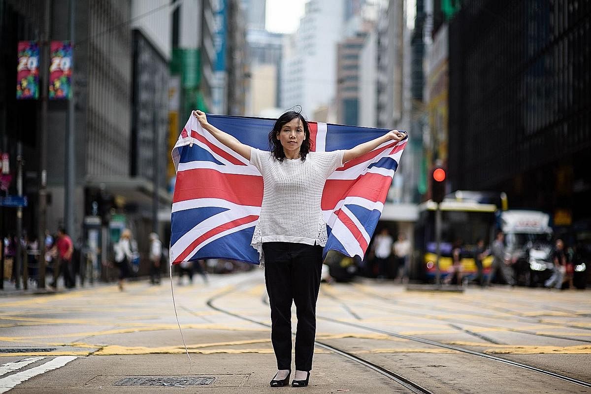Hong Kong artist and designer Alice Lai, 39, who heads a small protest group called HK-UK Reunification Campaign, with the British flag. Ms Lai, who regularly flies Hong Kong's former colonial flag at political rallies, said: "Hong Kong and the UK co