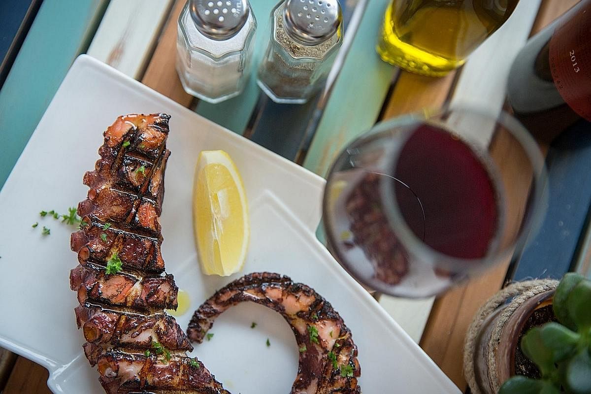 The grilled octopus (above) is tender with an appealing aroma of smoke and oregano and the Greek yogurt topped with honey and walnuts (left) is delicious.