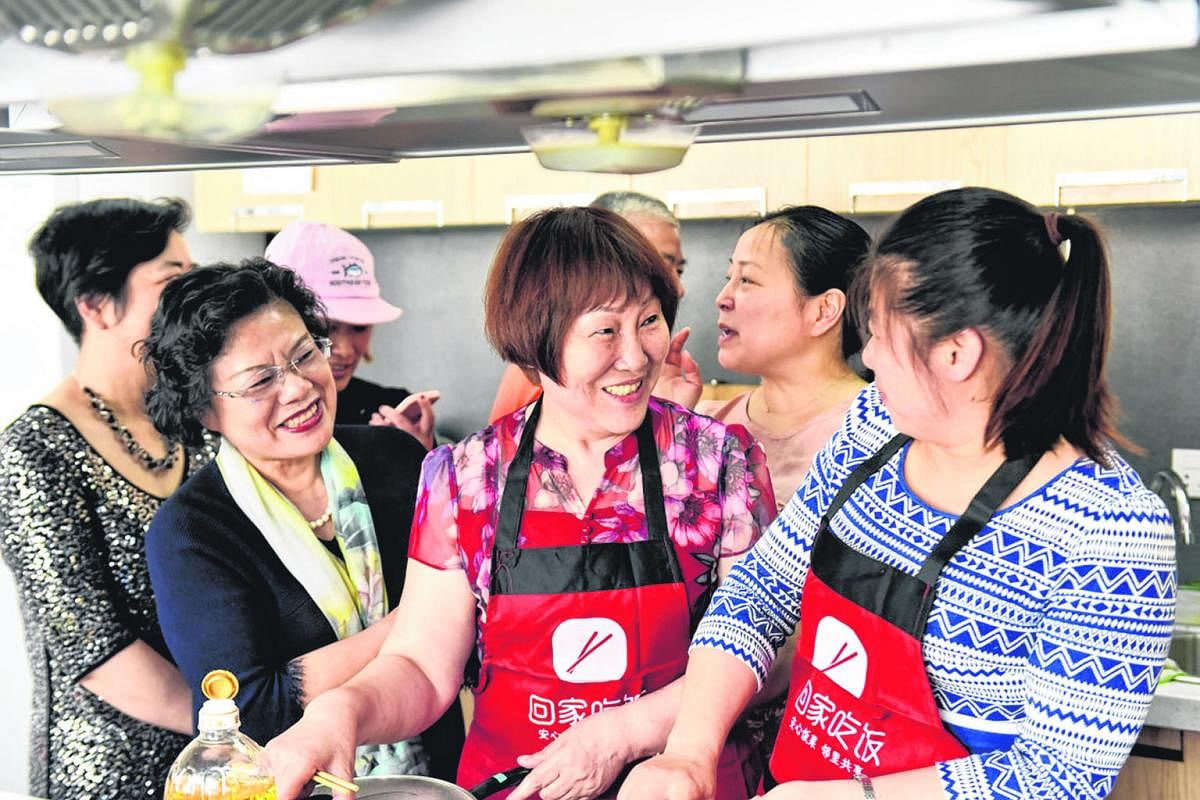 Chefs from Home Cook exchanging culinary tips at a gathering. Home Cook organises cooking competitions and other bonding activities for its chefs every week to encourage them to learn from one another. The company, which has two million registered us