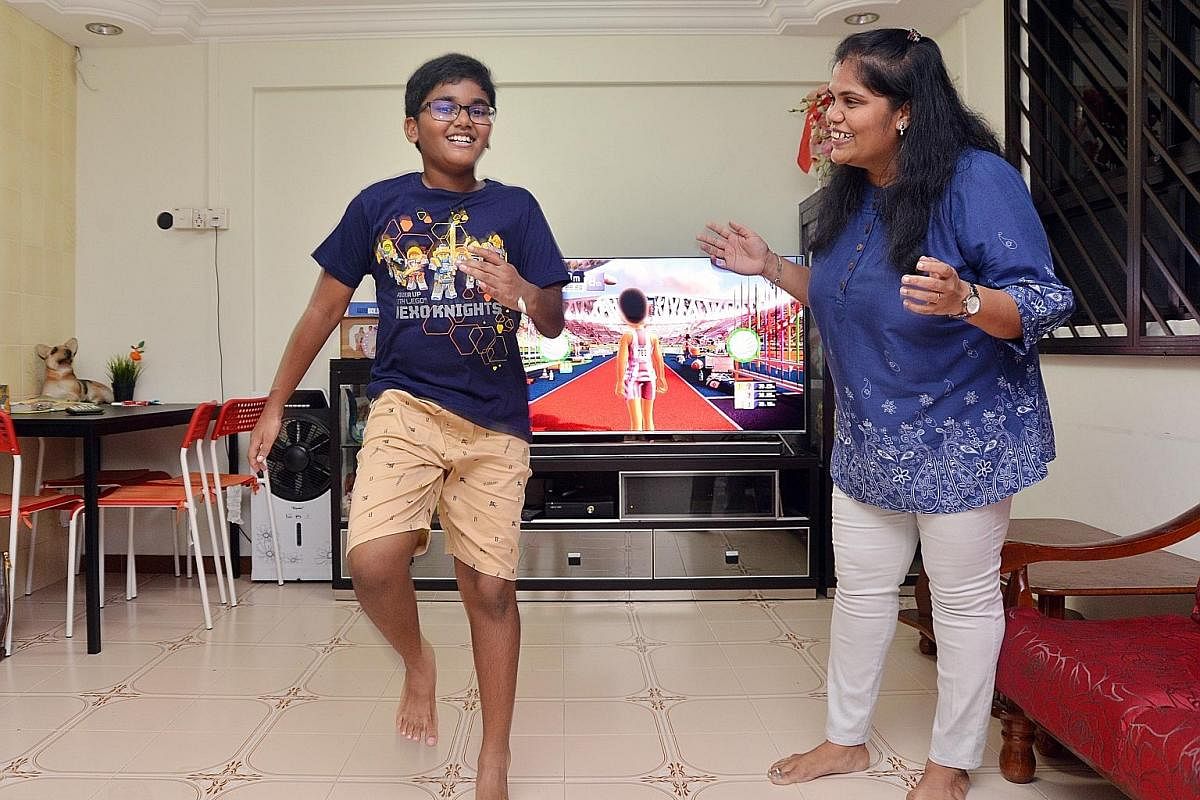 Ramachandran Nikhil, 10, and his mum, IT professional Kasi Kanimozhi. Nikhil is playing a video game that requires him to be active.
