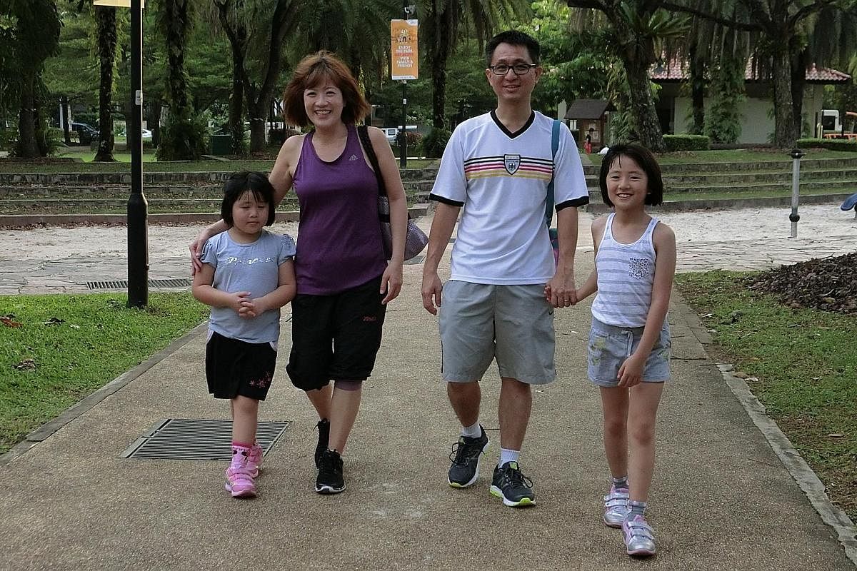 Yan Jie, six, with mum Wendy Wong, dad Tan Cheng Kang and sister Yan Yu, nine, taking a stroll in the park.