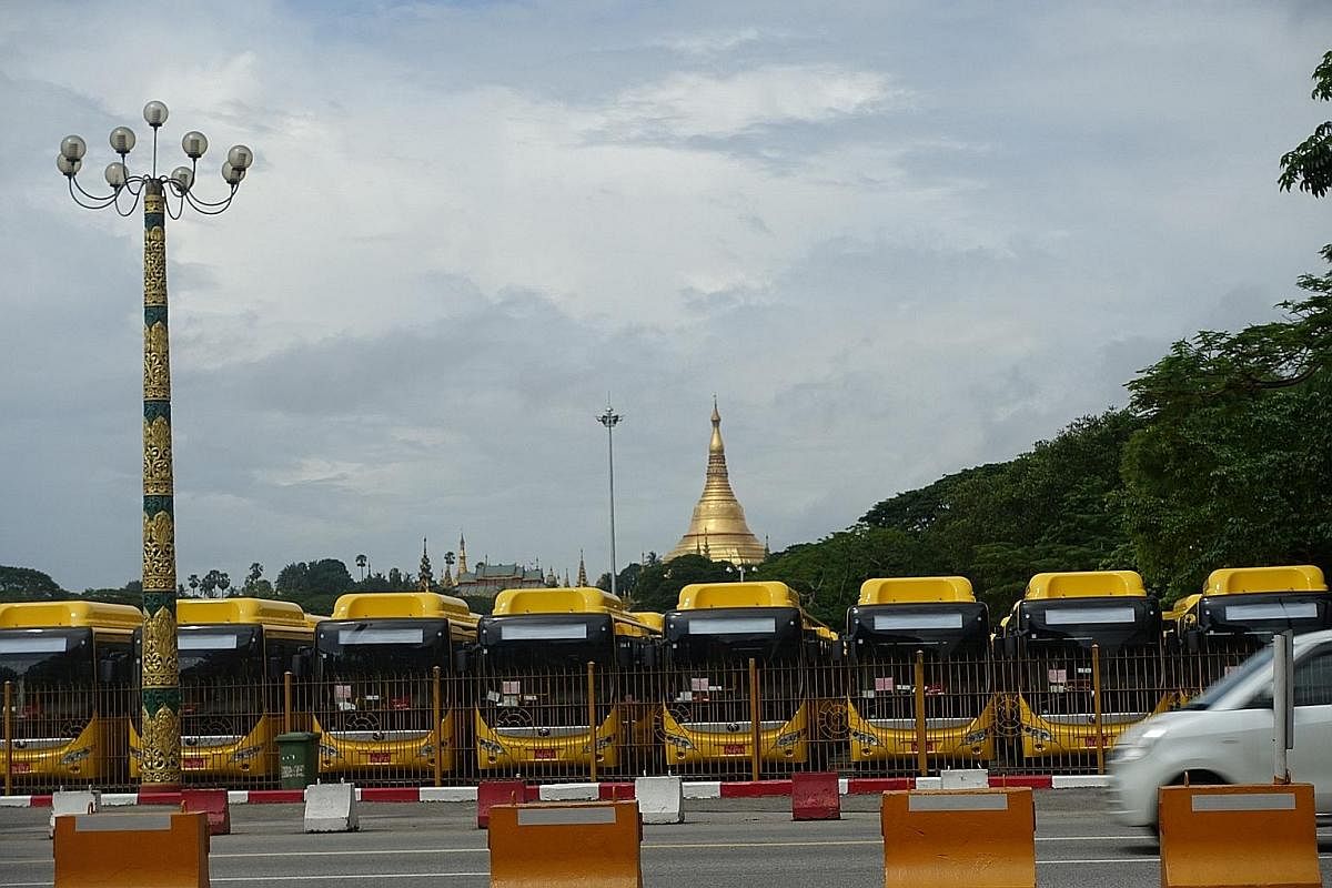 New China-made buses along Pyay Road in Yangon, waiting to be deployed once the paperwork is in order. Motorcycles and bicycles are banned in downtown Yangon. Left with few other choices, 60.8 per cent of commuters turn to buses, according to the Japan In