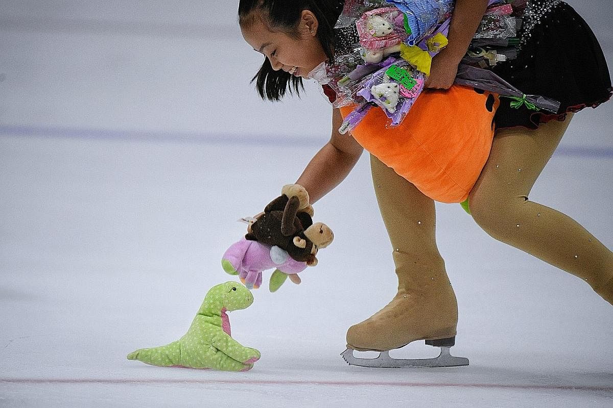 Clockwise from above: A girl picks up soft toys and flowers from fans of Malaysian figure skater Julian Yee after his gold medal-winning performance. The Games organisers' target audience must have included young supporters and this baby did not disa
