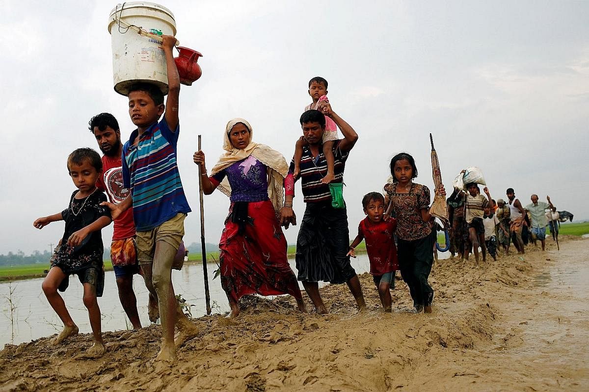 Rohingya refugees after crossing the Myanmar border into Bangladesh on Sunday. Rights monitors and the Rohingya say the Myanmar army is trying to force Rohingya out with a campaign of arson and killings.