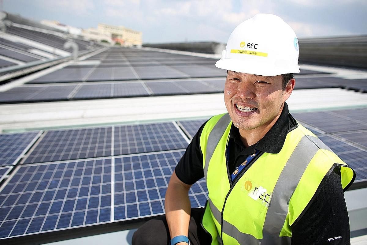Mr James Ong of REC Solar on the rooftop of Asia Pacific Breweries Singapore's brewery in Jalan Ahmad Ibrahim. The panels were installed by the solar panel manufacturer in 2015.