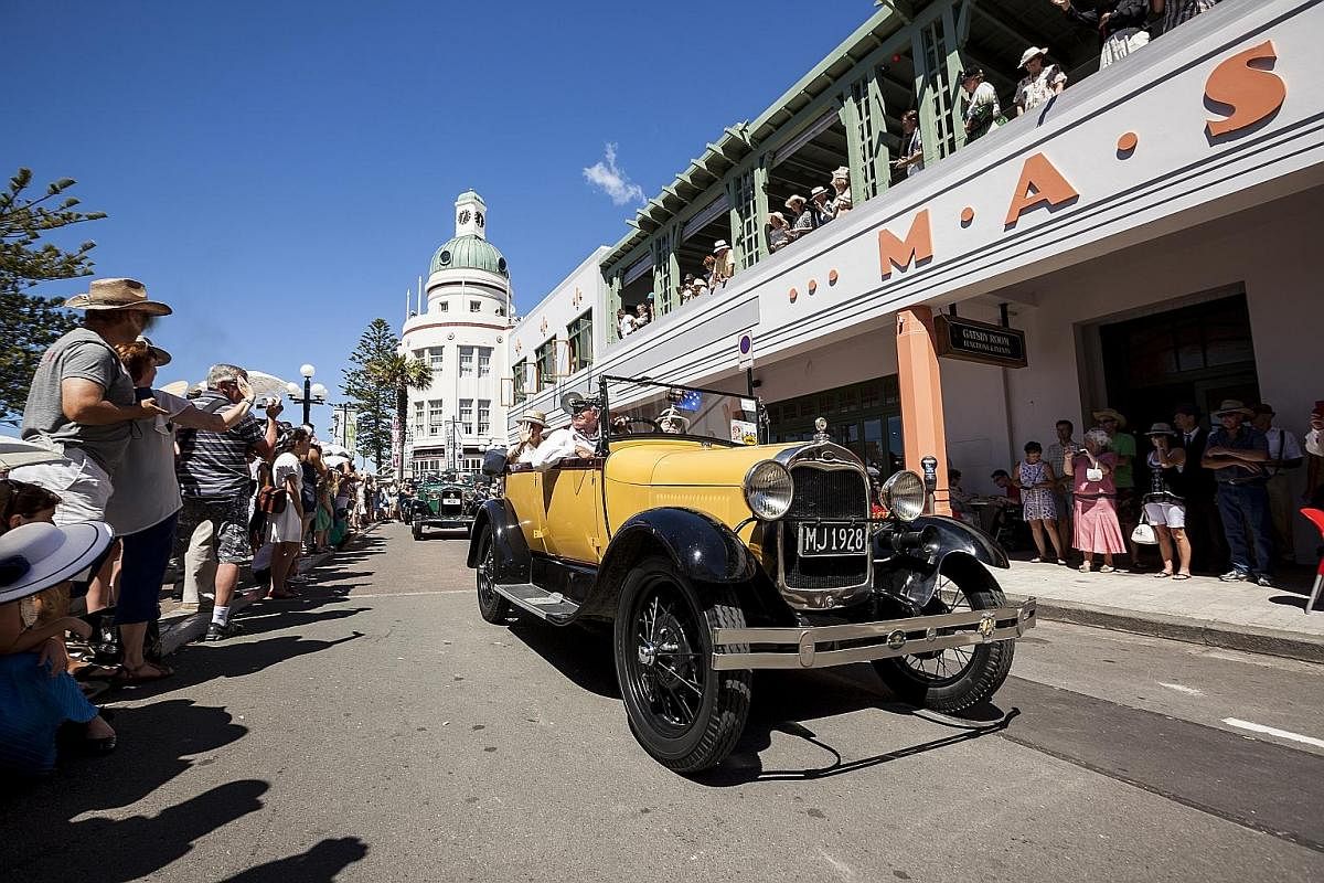 Vintage cars outside the Art Deco Masonic Hotel in the coastal city of Napier. Go on a kayak tour to see glow worms in a dark canyon in Tauranga. Riders on a cycling tour in Hawke's Bay, which is part of the Pacific Ocean. The beach town of Mount Mau