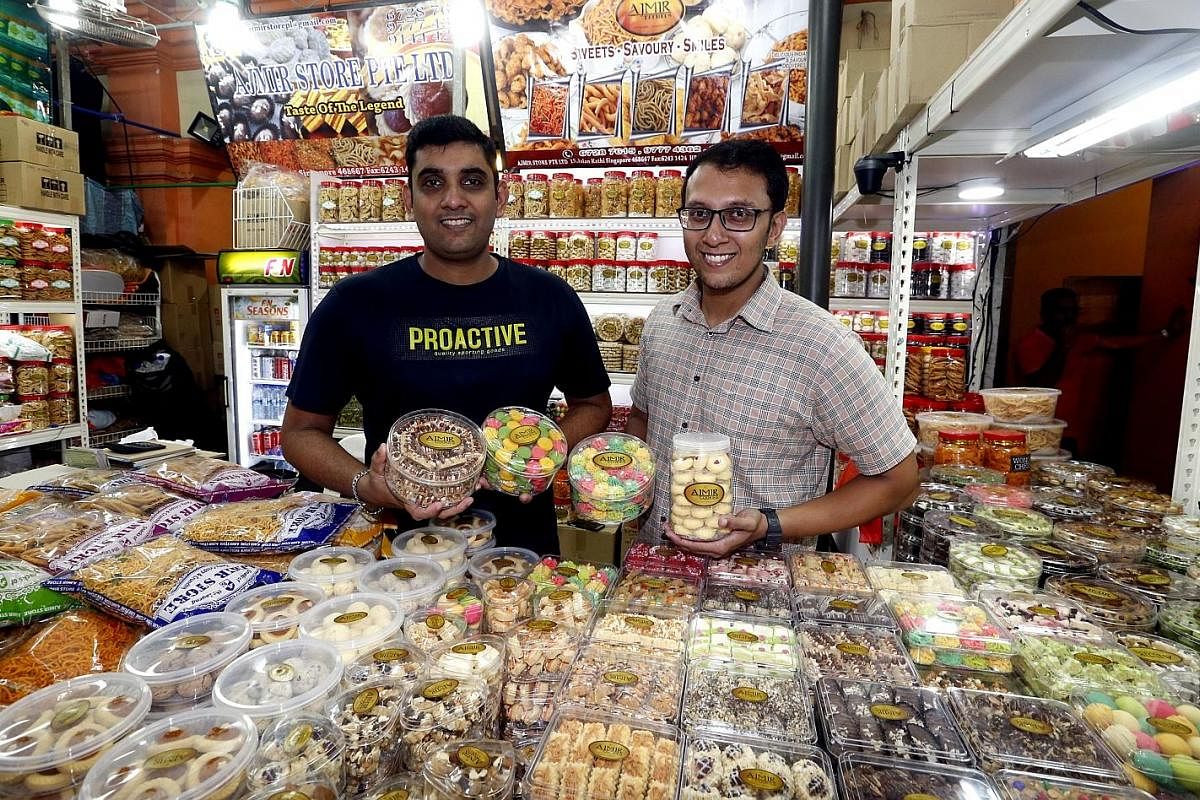 Brothers Mohamed Faizal (left) and Mohamed Ismail, who run Ajmir Store in the Deepavali Festival Village, with their new snacks.