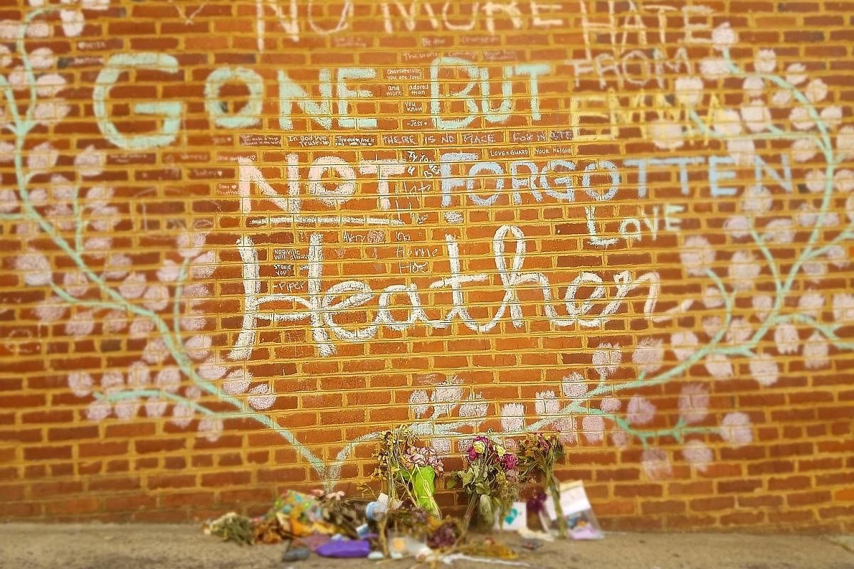 Flowers left at the spot where Ms Heather Heyer was killed on Aug 12 in Charlottesville, Virginia, after a young neo-Nazi slammed his car into a crowd.