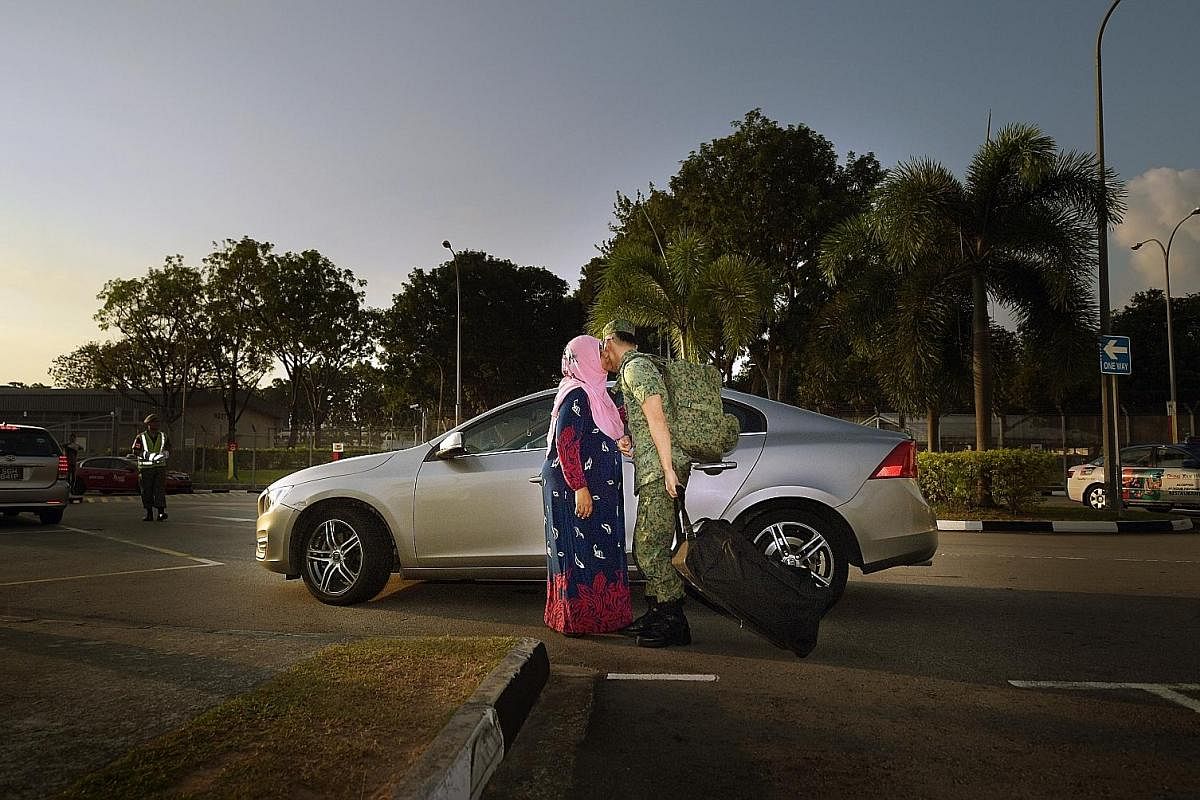 Corporal First Class (NS) Muhammad Asri, 26, a sales executive at an engineering company, says goodbye to his mother, Madam Rosmiati Hambali, 52, outside Jurong Camp II. CFC (NS) Muhammad is an assistant layer with a mortar team in the 746th Battalio