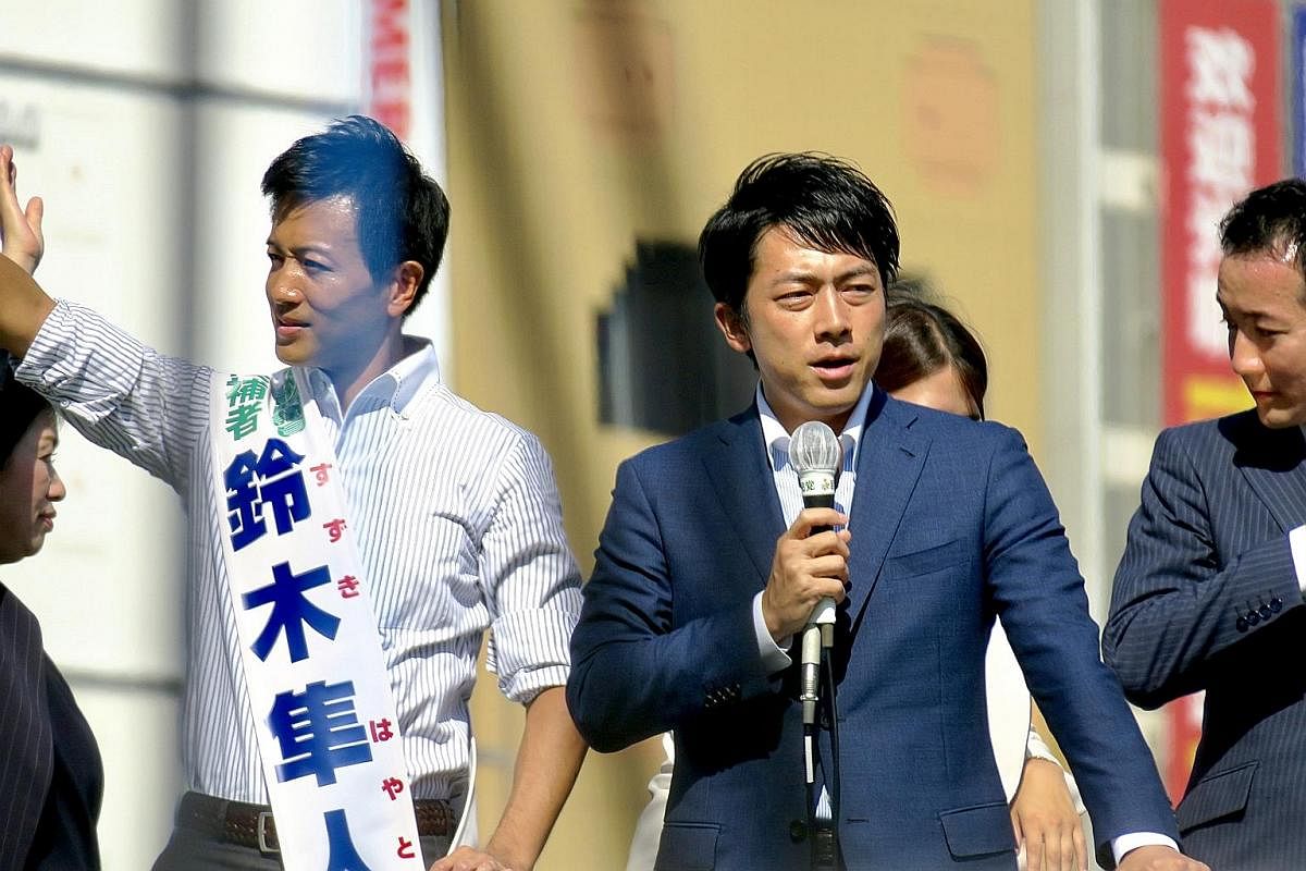 Japanese Prime Minister Shinzo Abe speaking to voters from the top of a truck in Hokkaido on Sunday. Under strict campaigning rules, door-to-door soliciting is banned and there is a cap on the number of party volunteers (up to 15) allowed at each ral
