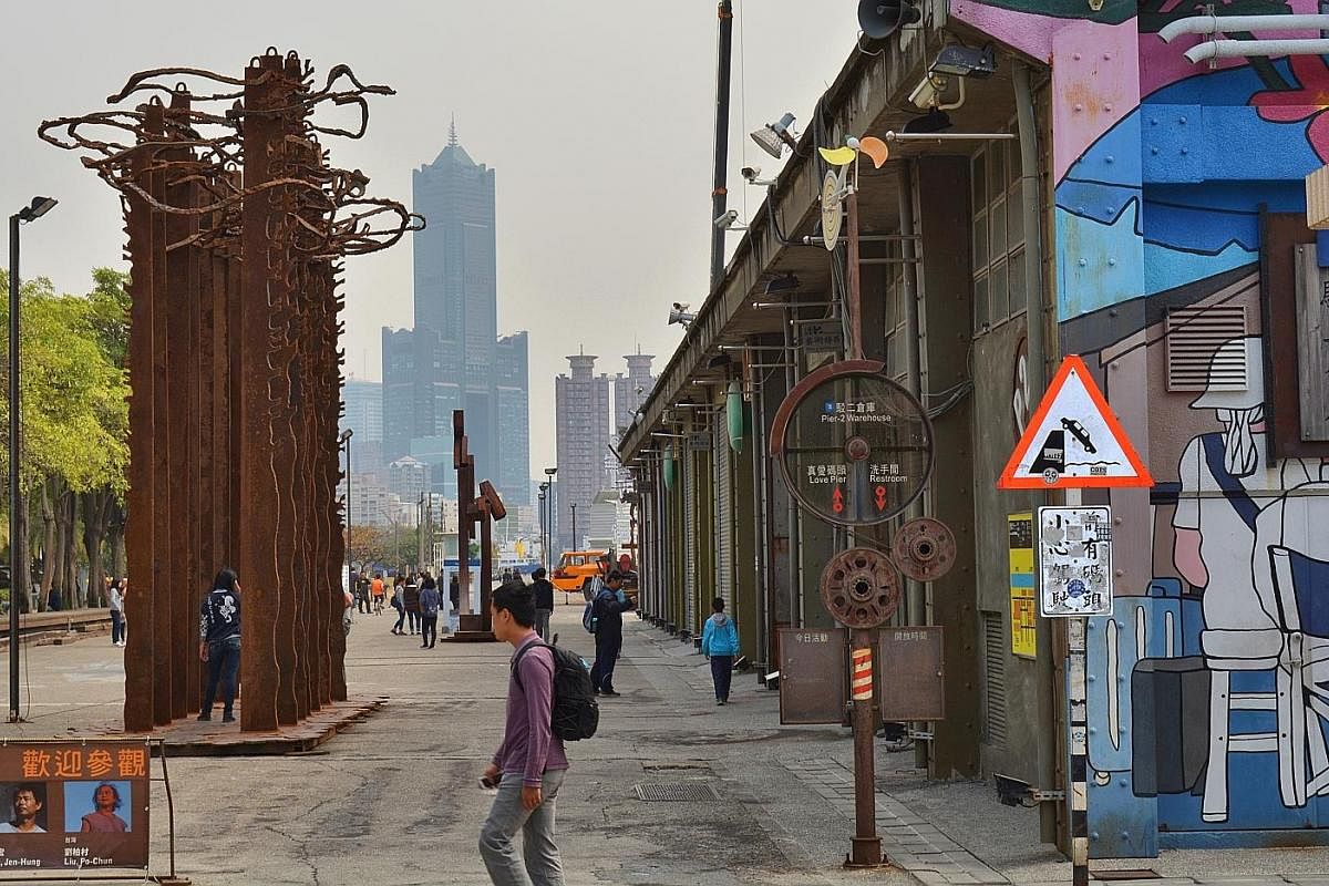 Kaohsiung's tallest building, Tuntex 85 Sky Tower (above), looms in the distance and muscle-men outlines (right) line up in a whimsical art installation. (Above) Colourful murals are a feature throughout Pier-2 Art Center. (Left) Giant installations,