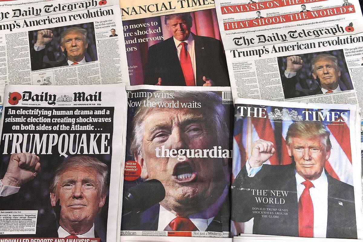 Above: A selection of front pages of British newspapers showing the global reaction to Mr Donald Trump's shock US presidential victory on Nov 10 last year. Top: Then President-elect Donald Trump on stage with his family, celebrating his winning the U