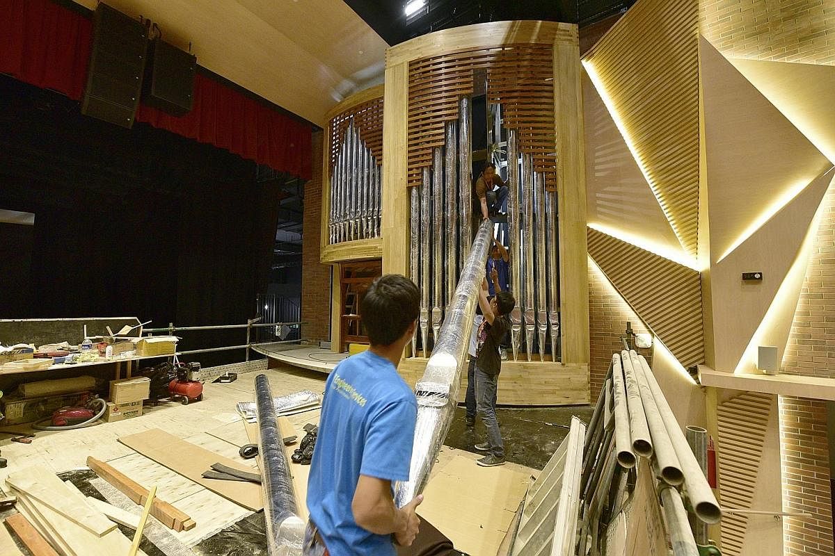 A specialist team carries the wooden base of the organ's facade into the Alleyn Theatre in Dulwich College Singapore. It took 15 craftsmen about a year to make the organ's parts in Diego Cera's workshop in Las Pinas, a city near Manila. The organ was