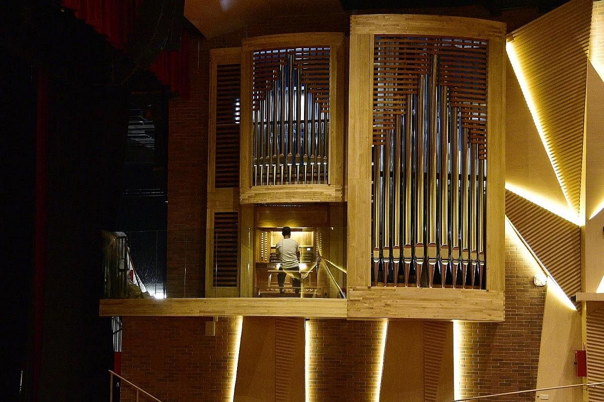 A specialist team carries the wooden base of the organ's facade into the Alleyn Theatre in Dulwich College Singapore. It took 15 craftsmen about a year to make the organ's parts in Diego Cera's workshop in Las Pinas, a city near Manila. The organ was