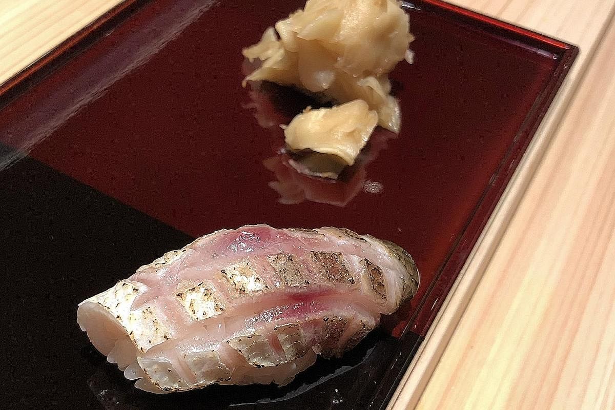 Ishi's kamasu sushi (above) has its skin scored and slightly torched to give it a smoky taste and its rice bowl (below) topped with uni and ikura rounds off the meal.