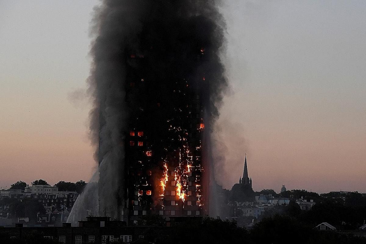 GRENFELL TOWER FIRE: Flames and smoke engulfing the Grenfell Tower apartment block in West London on June 14. The inferno spread rapidly through the 24-storey building, killing 71 people. Investigators believe flammable cladding on its exterior allow