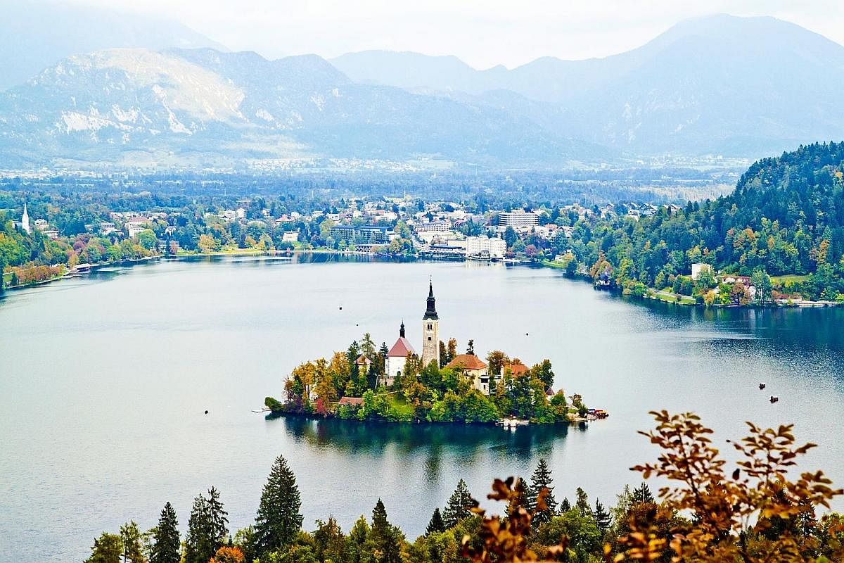 Lake Bled (above), with its fairy-tale, church-crowned island in the middle of a pristine lake; and the Predjama castle (left), a dramatic Renaissance castle built into a cave within the Karst region. The Franciscan Church of the Annunciation and the