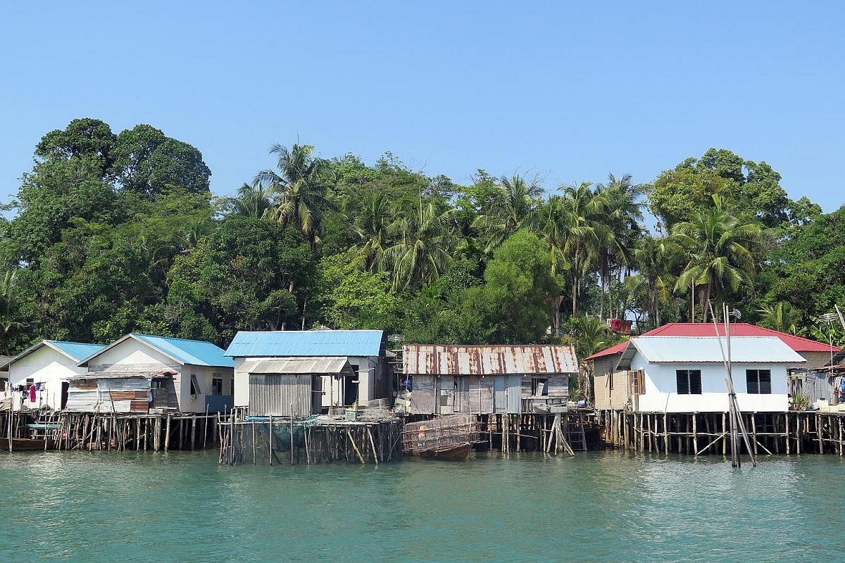 Batam's sea gypsy community live in huts (above) built over the water and local village life (below) moves at an easy pace. A kelong restaurant in Batam that serves seafood fresh from the ocean. The five-star Radisson Golf & Convention Center Batam (