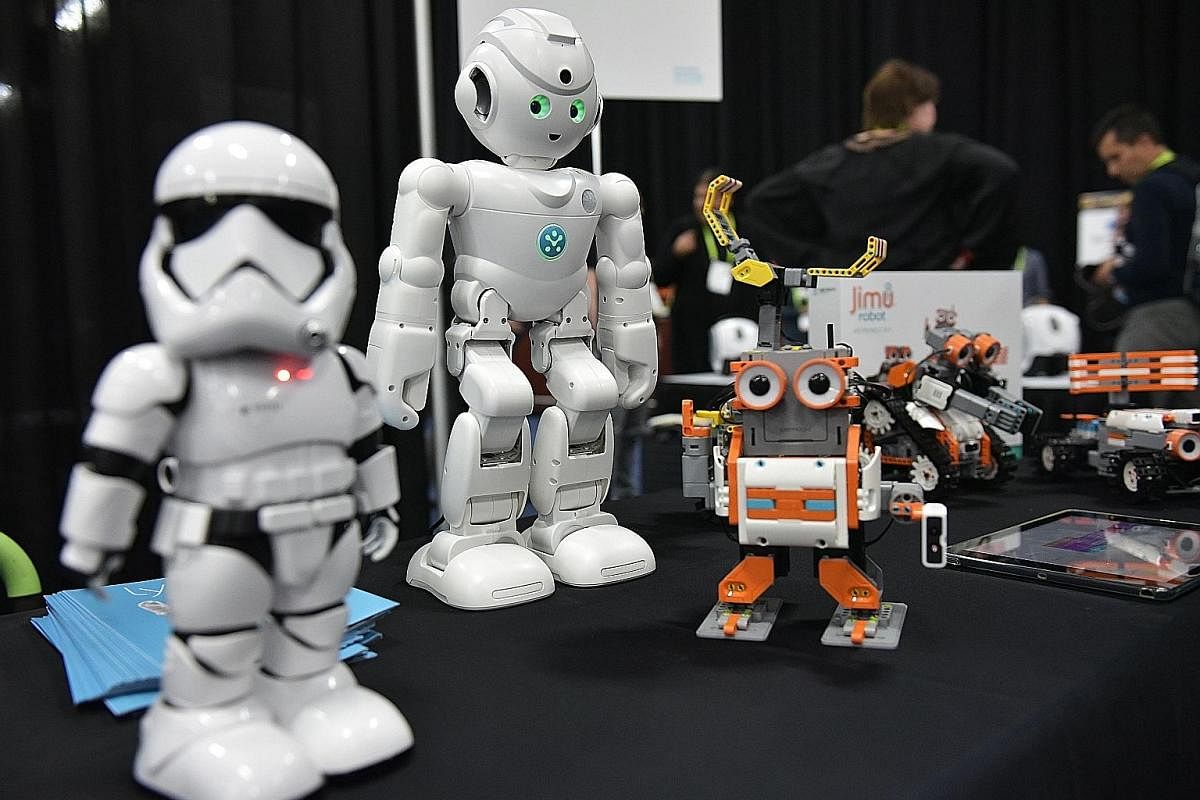 Ubtech robots including the First Order "Stormtrooper" (left) and the Amazon Alexa voice assistant enabled "lynx" (centre) at CES 2018 in Las Vegas.