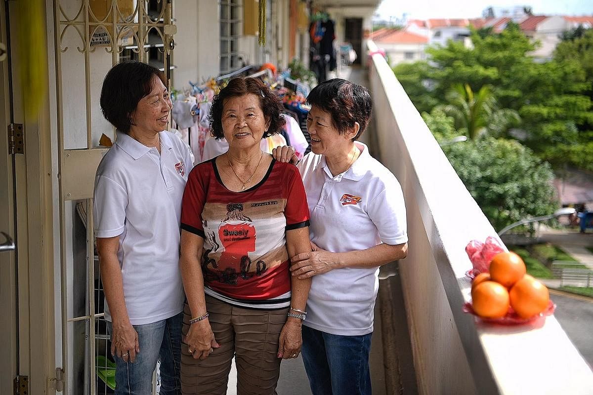 Madam Wong Yoke Hun (far left) and Madam Ng Geok Thuay are volunteer befrienders who regularly visit senior neighbours such as Madam Tan Ah Hiang (centre) to chat with them.