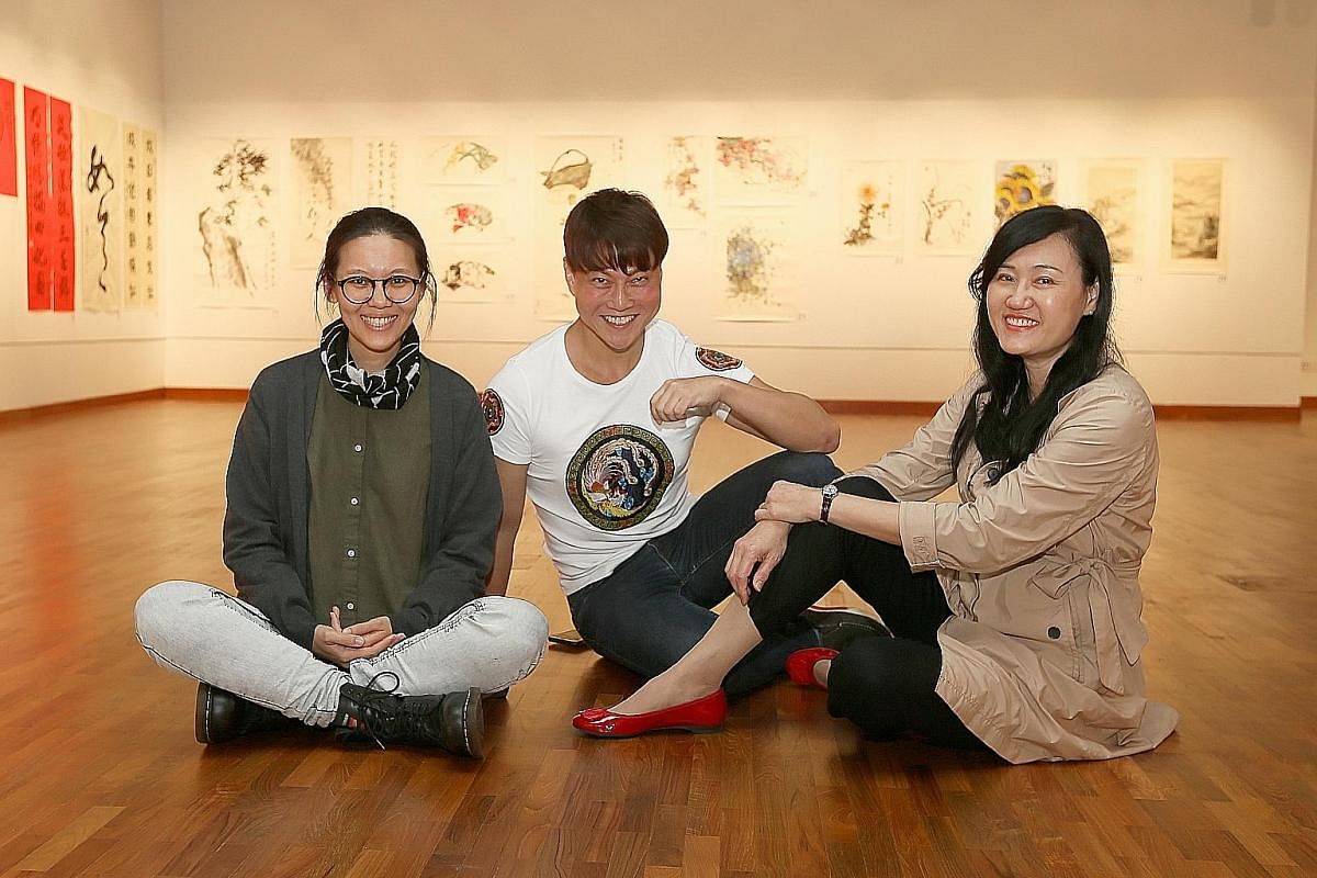 Students majoring in Chinese ink at the Nanyang Academy of Fine Arts include (from far left) Lee Ju-Lyn, Ernest Seah Chien Soo and Ho Seok Kee. Student Nur Hikmah Mohamed Tahir is exhibiting her work, We Are More Than Our Veil, at the school's ongoin