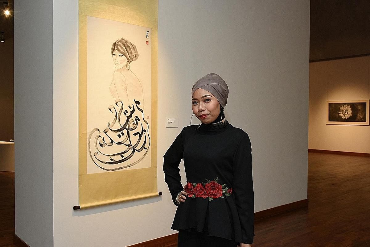 Students majoring in Chinese ink at the Nanyang Academy of Fine Arts include (from far left) Lee Ju-Lyn, Ernest Seah Chien Soo and Ho Seok Kee. Student Nur Hikmah Mohamed Tahir is exhibiting her work, We Are More Than Our Veil, at the school's ongoin