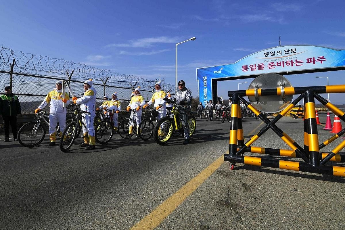 Above, from left: Torchbearers on the road leading to the border truce village of Panmunjom during the Olympic Torch Relay on Jan 19. Ms Hyon Song Wol, head of North Korea's Samjiyon Orchestra which will perform at the Games, arriving in Gangneung in