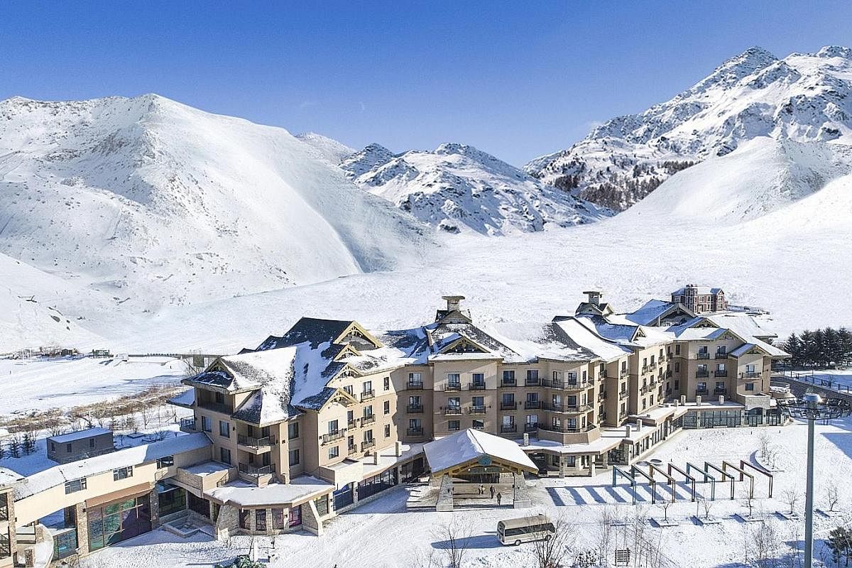 The resort (above) greets skiers with hot chocolate and mulled wine or apple cider after a day on the slopes and provides entertainment (left) at night. Club Med Beidahu in north-east Jilin province has 22 runs, most of which are for beginner and int